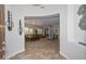 Open-concept living room and dining area with tile flooring and contemporary chandeliers at 13353 W Gloria Ln, Peoria, AZ 85383