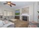 Comfortable living room features a fireplace, ceiling fan, and stylish furniture at 13353 W Gloria Ln, Peoria, AZ 85383