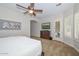 A main bedroom featuring a ceiling fan and an exterior door for the patio at 13353 W Gloria Ln, Peoria, AZ 85383