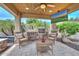 Outdoor kitchen boasts a built-in grill, cozy seating under a covered patio, and lush plants for a perfect alfresco experience at 13353 W Gloria Ln, Peoria, AZ 85383