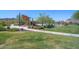A community playground and park surrounded by lush green grass and desert landscaping at 13353 W Gloria Ln, Peoria, AZ 85383