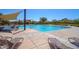 Community pool with lounge chairs, umbrellas, and plenty of space for residents to relax at 13353 W Gloria Ln, Peoria, AZ 85383