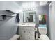 Modern bathroom featuring a white vanity, stylish mirror, and shelves, creating a fresh aesthetic at 13614 N 33Rd Ave, Phoenix, AZ 85029
