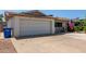 Home's front exterior featuring a two-car garage, wide driveway and desert landscaping at 13614 N 33Rd Ave, Phoenix, AZ 85029