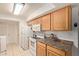 Well-lit kitchen with modern appliances, light wood cabinets, and tile flooring at 13614 N 33Rd Ave, Phoenix, AZ 85029