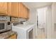 Convenient laundry room with washer, dryer, cabinets and a toilet at 13614 N 33Rd Ave, Phoenix, AZ 85029