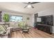 Comfortable living room with a sectional sofa, a ceiling fan and laminate flooring at 13614 N 33Rd Ave, Phoenix, AZ 85029