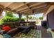 Covered patio featuring a comfortable sectional sofa, rug, and outdoor furniture for relaxation at 13614 N 33Rd Ave, Phoenix, AZ 85029
