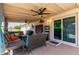 Relaxing covered patio with ceiling fan, comfortable seating, and sliding glass doors for seamless indoor-outdoor living at 13614 N 33Rd Ave, Phoenix, AZ 85029