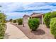 Backyard showcasing a landscaped walkway, birdbath and well-maintained shrubs in a desert landscape at 1395 E Runaway Bay Dr, Chandler, AZ 85249