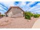 A charming home with a low-maintenance landscape and gravel, shrubbery, and a glimpse of blue sky at 1395 E Runaway Bay Dr, Chandler, AZ 85249
