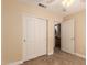 Bedroom featuring a closet, access to the bathroom, neutral walls and tile floors at 1395 E Runaway Bay Dr, Chandler, AZ 85249