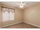Neutral bedroom with tile floors, ceiling fan and a window letting in natural light at 1395 E Runaway Bay Dr, Chandler, AZ 85249