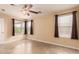 Bedroom featuring dual windows, neutral walls, tile floors, and ceiling fan at 1395 E Runaway Bay Dr, Chandler, AZ 85249