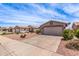 Street view of homes showcasing desert landscaping, concrete driveways, and neutral paint colors at 1395 E Runaway Bay Dr, Chandler, AZ 85249
