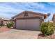 Side view of a home featuring a large two-car garage with an extended driveway at 1395 E Runaway Bay Dr, Chandler, AZ 85249