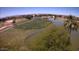 Overhead view of a well-maintained golf course with mature trees and water features in a residential area at 1395 E Runaway Bay Dr, Chandler, AZ 85249
