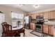 Well lit eat-in kitchen area with stainless steel appliances, granite countertops and wooden cabinets at 1395 E Runaway Bay Dr, Chandler, AZ 85249