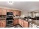 Kitchen featuring granite countertops, stainless steel appliances, wooden cabinets and tile backsplash at 1395 E Runaway Bay Dr, Chandler, AZ 85249