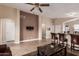 Open concept living room with tile floors, breakfast bar seating, and a neutral color scheme at 1395 E Runaway Bay Dr, Chandler, AZ 85249