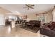 Spacious open concept living room and kitchen featuring tile floors, ceiling fan, and eat-in breakfast bar at 1395 E Runaway Bay Dr, Chandler, AZ 85249