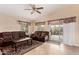 Inviting living room with tile floors, ceiling fan, large windows, and comfortable seating at 1395 E Runaway Bay Dr, Chandler, AZ 85249