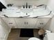 Bathroom vanity featuring white marble countertop, black fixtures, and white cabinets at 1449 E Highland Ave # 25, Phoenix, AZ 85014