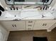 Bathroom featuring a double sink vanity with elegant marble countertops and white cabinetry at 1449 E Highland Ave # 25, Phoenix, AZ 85014