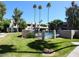 Exterior shot of community pool area showcasing lush landscaping and well-maintained grounds at 1449 E Highland Ave # 25, Phoenix, AZ 85014