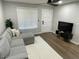 Living room showcasing a gray sectional sofa, television set, and a bright window at 1449 E Highland Ave # 25, Phoenix, AZ 85014
