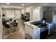 Living area with a dining table, sofa, and adjacent kitchen featuring modern appliances at 1449 E Highland Ave # 25, Phoenix, AZ 85014