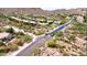 Aerial view of a desert community showcases the neighborhood layout and surrounding landscape at 14523 E Charter Oak Dr, Scottsdale, AZ 85259