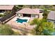 Aerial view of a private backyard featuring a sparkling pool, spa, and manicured landscaping, creating a serene outdoor oasis at 14523 E Charter Oak Dr, Scottsdale, AZ 85259