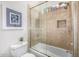 Bathroom showcasing a shower-tub combo with glass doors and decorative tile surround at 14523 E Charter Oak Dr, Scottsdale, AZ 85259
