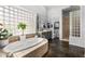 Relaxing bathroom with soaking tub, block windows, walk-in shower, and double vanity at 14523 E Charter Oak Dr, Scottsdale, AZ 85259