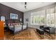 Bright bedroom with large windows, wood floors, and a comfortable seating area at 14523 E Charter Oak Dr, Scottsdale, AZ 85259