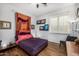 Stylish bedroom with wood floors, ceiling fan, natural light, and unique decor at 14523 E Charter Oak Dr, Scottsdale, AZ 85259