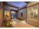 Charming courtyard entrance with desert landscaping, pavers, and architectural details, leading to a welcoming home environment at 14523 E Charter Oak Dr, Scottsdale, AZ 85259