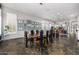 Spacious dining room with slate floors, shuttered windows, a wood table, and gallery art at 14523 E Charter Oak Dr, Scottsdale, AZ 85259
