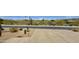 Expansive driveway leads to a desert home with native plants and serene mountain views, offering privacy and natural beauty at 14523 E Charter Oak Dr, Scottsdale, AZ 85259