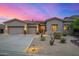 Beautiful desert home boasts a three-car garage, landscaped yard, and modern design elements, creating an inviting curb appeal at 14523 E Charter Oak Dr, Scottsdale, AZ 85259
