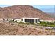 Scenic view of a modern hotel nestled against a backdrop of majestic mountains at 14523 E Charter Oak Dr, Scottsdale, AZ 85259