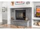 Cozy fireplace with stone surround, adding warmth and style to the living space, complemented by tasteful decor and ambient lighting at 14523 E Charter Oak Dr, Scottsdale, AZ 85259