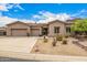 Charming single-story home with a three-car garage and manicured desert landscaping at 14523 E Charter Oak Dr, Scottsdale, AZ 85259