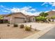 Attractive home featuring a spacious three-car garage and desert landscaping at 14523 E Charter Oak Dr, Scottsdale, AZ 85259