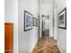 Hallway featuring beautiful wood-look floors and artistic decor on the walls at 14523 E Charter Oak Dr, Scottsdale, AZ 85259