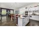 Modern kitchen flows into the dining area, featuring white cabinetry, and an island at 14523 E Charter Oak Dr, Scottsdale, AZ 85259