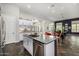 Modern kitchen features white cabinets, stainless steel appliances, and an island with bar seating at 14523 E Charter Oak Dr, Scottsdale, AZ 85259