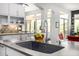 Modern kitchen island with a sleek sink, designer faucet, and views of the outdoor area at 14523 E Charter Oak Dr, Scottsdale, AZ 85259