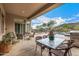 Covered patio with dining set and grill, offering a relaxing outdoor space overlooking the pool and desert landscape at 14523 E Charter Oak Dr, Scottsdale, AZ 85259